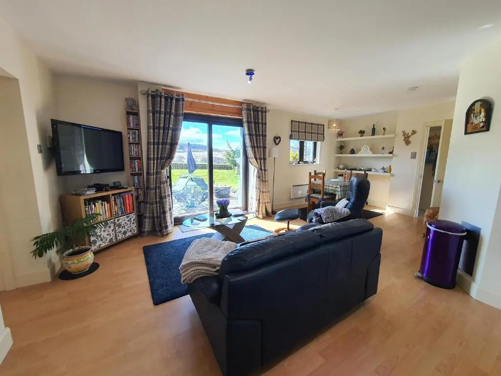 a living room with a couch and a tv at Lindas Retreats Self catering accommodation 1 bedroom cottage or 3 bedroom House in Tomintoul