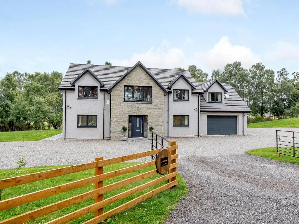 a house with a fence in front of it at Strathclaggan in Aberlour