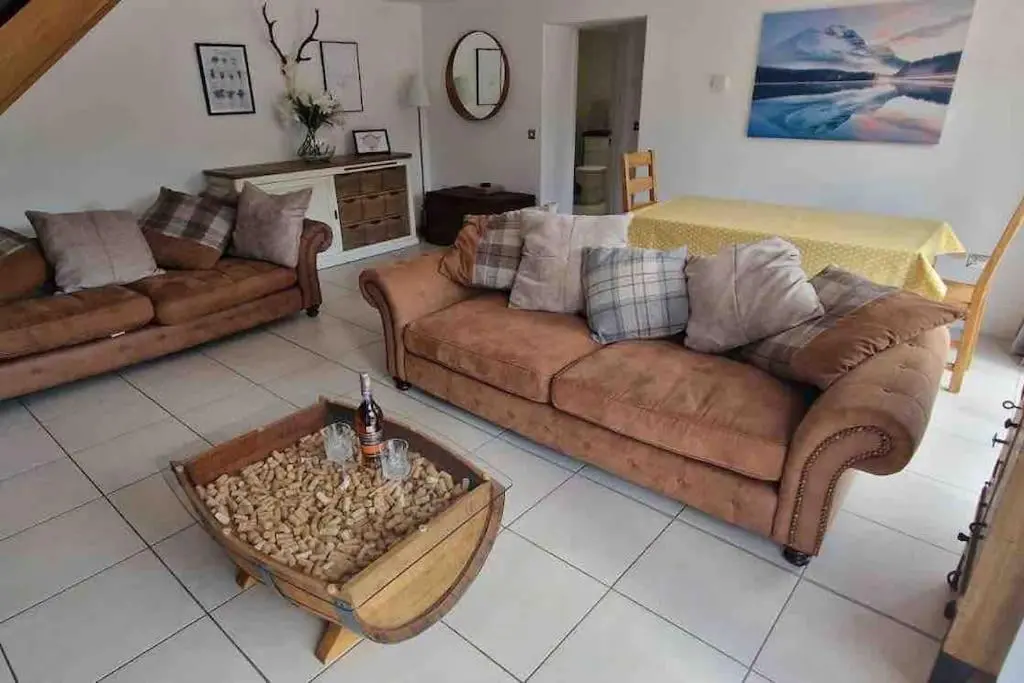a living room with two couches and a coffee table at Corriegorm Cottage, Aviemore in Aviemore