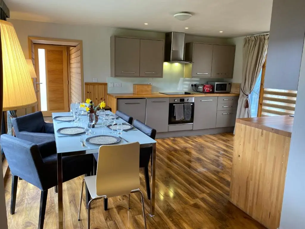 a kitchen and dining room with a table and chairs at Crofts Mill in Ballater