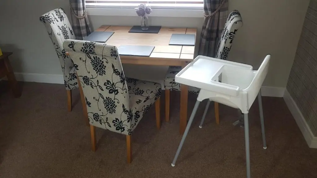 a dining room table with chairs and a sink at Ella's Hoose in Wick