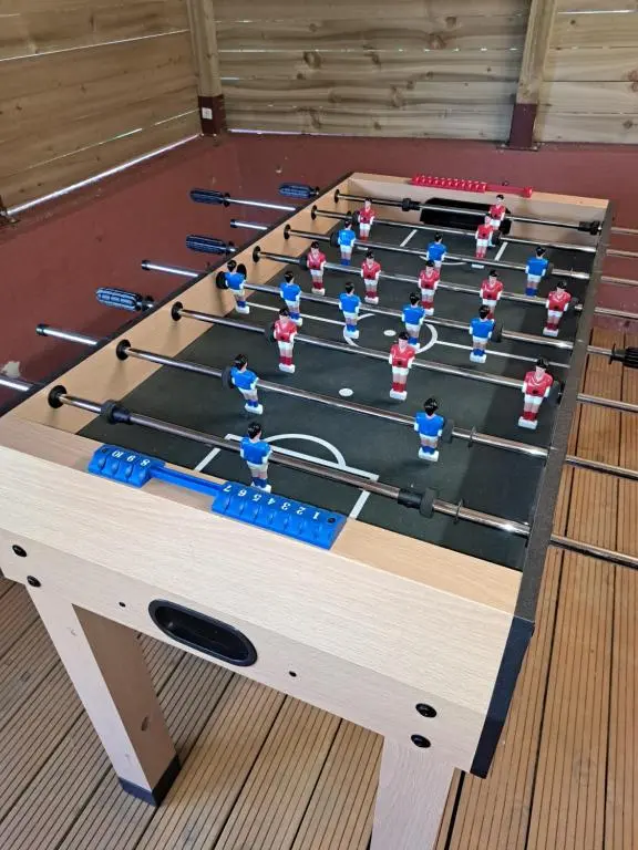 a ping pong table with a group of people at Clematis Cottage, Fortrose in Fortrose