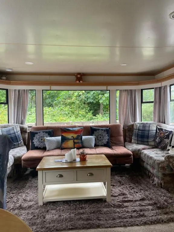 a living room with a couch and a coffee table at Caravan at Charleston House in Inverness
