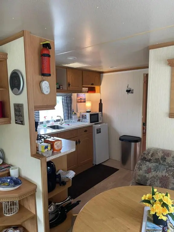 a small kitchen and living room of a caravan at Caravan at Charleston House in Inverness