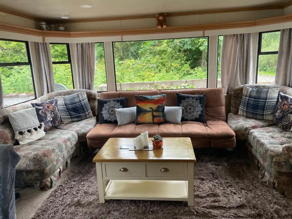 a living room with couches and a coffee table at Caravan at Charleston House in Inverness