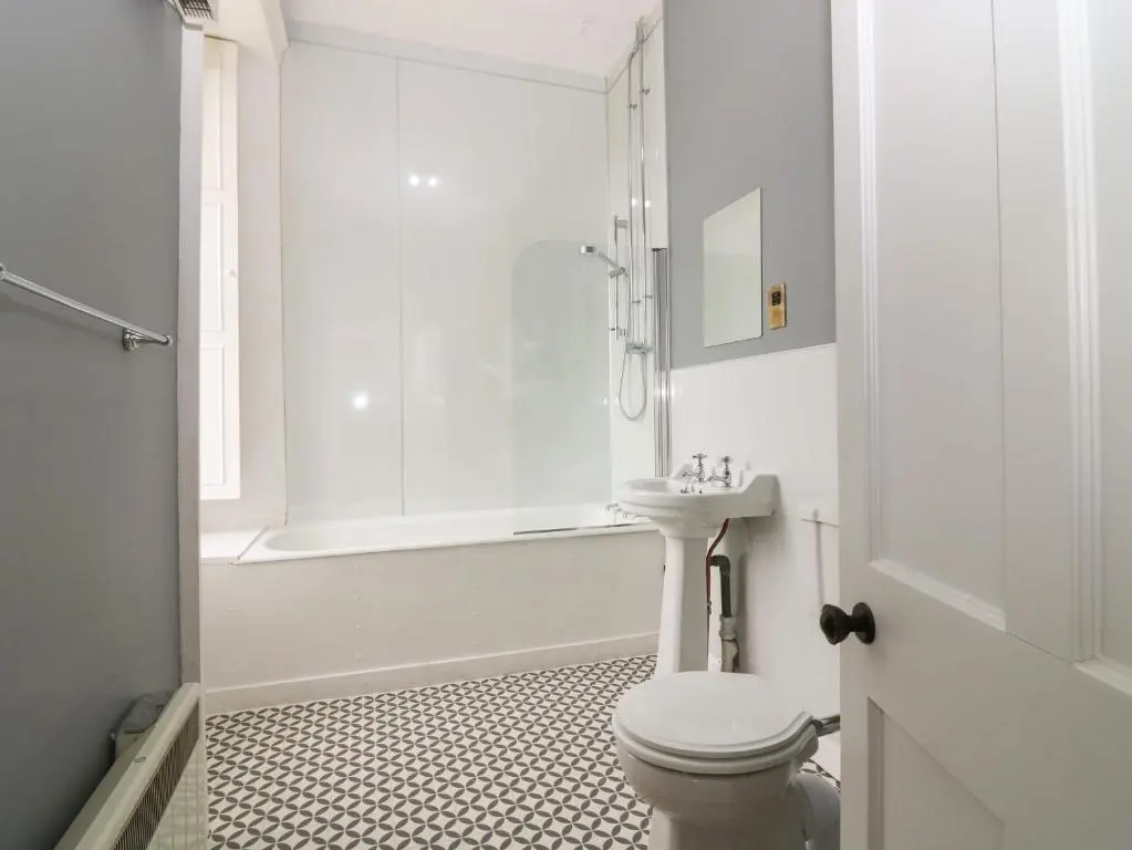 a white bathroom with a toilet and a sink at East Wing - Castle Fraser in Inverurie