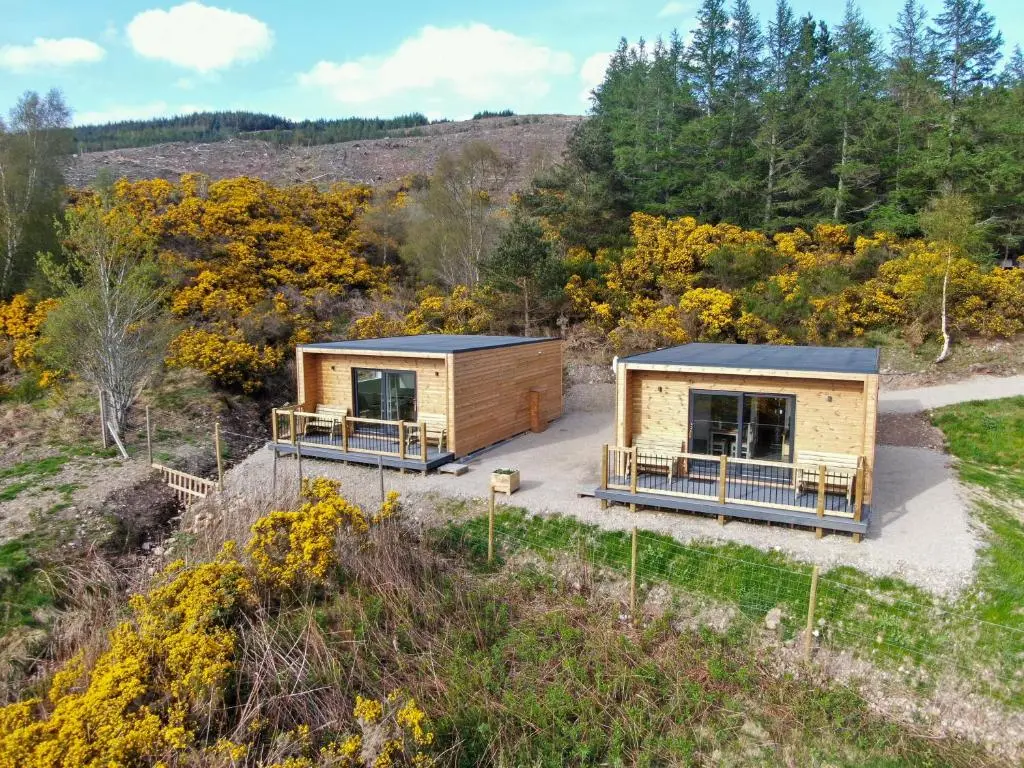 an aerial view of two modular homes in a forest at Ceol Mor Highland Lodges in Lairg