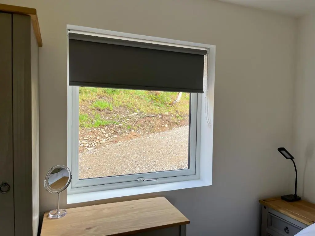 a window in a room with a window shade at Ceol Mor Highland Lodges in Lairg