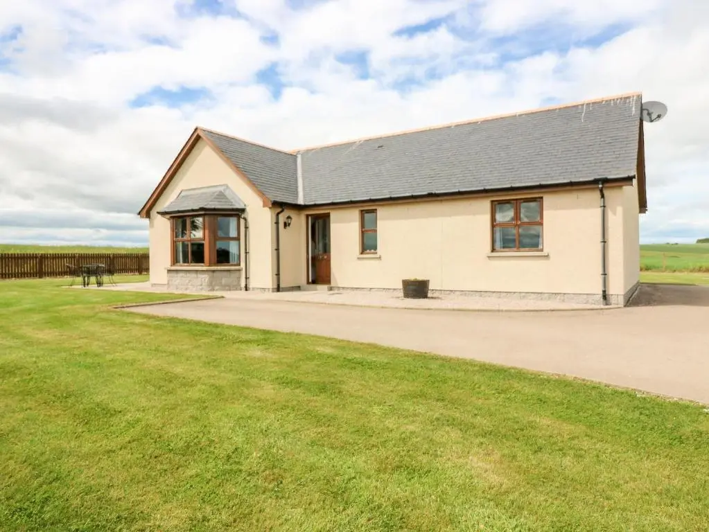a white house with a black roof at Kilnary Cottage in Ellon