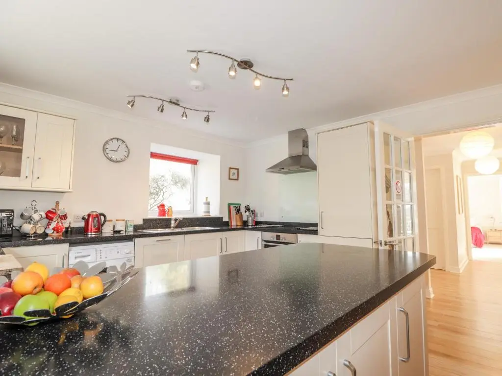 a kitchen with a bowl of fruit on a counter at Redburn Steading in Nairn