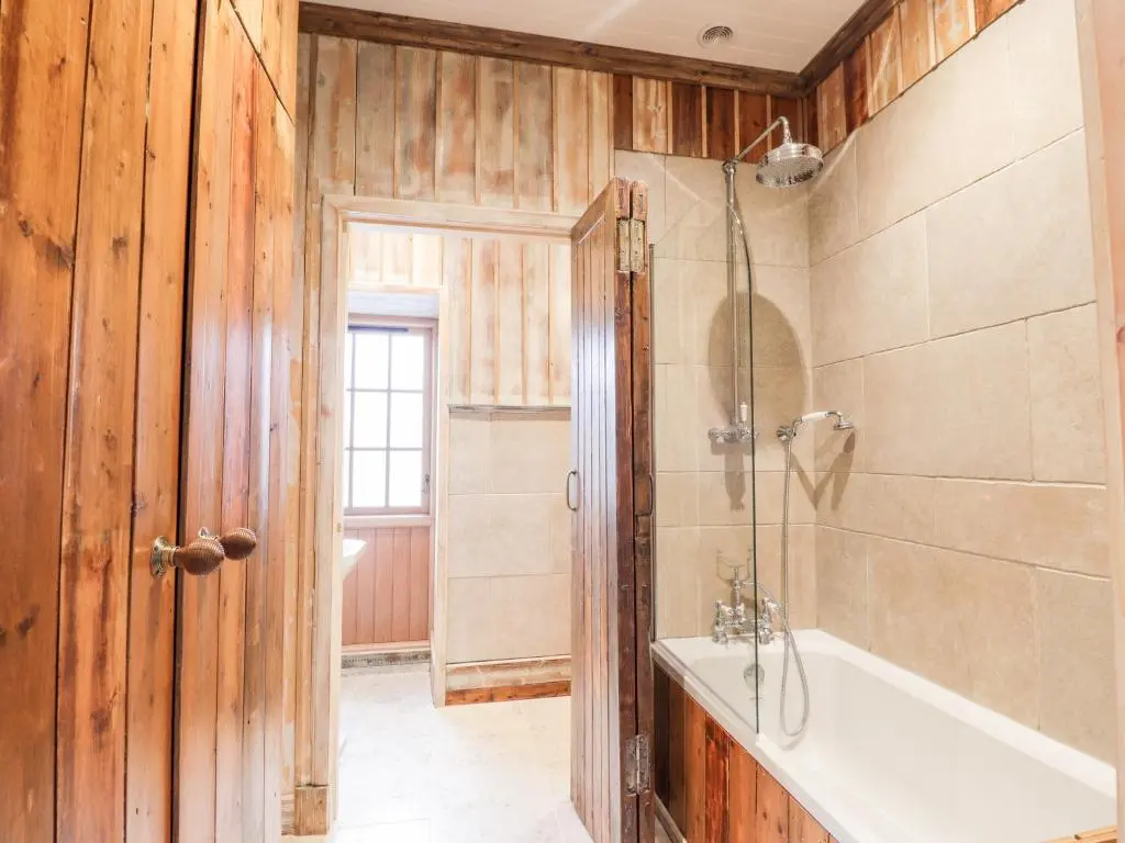 a bathroom with a tub and a sink and a shower at The Hen House in Beauly