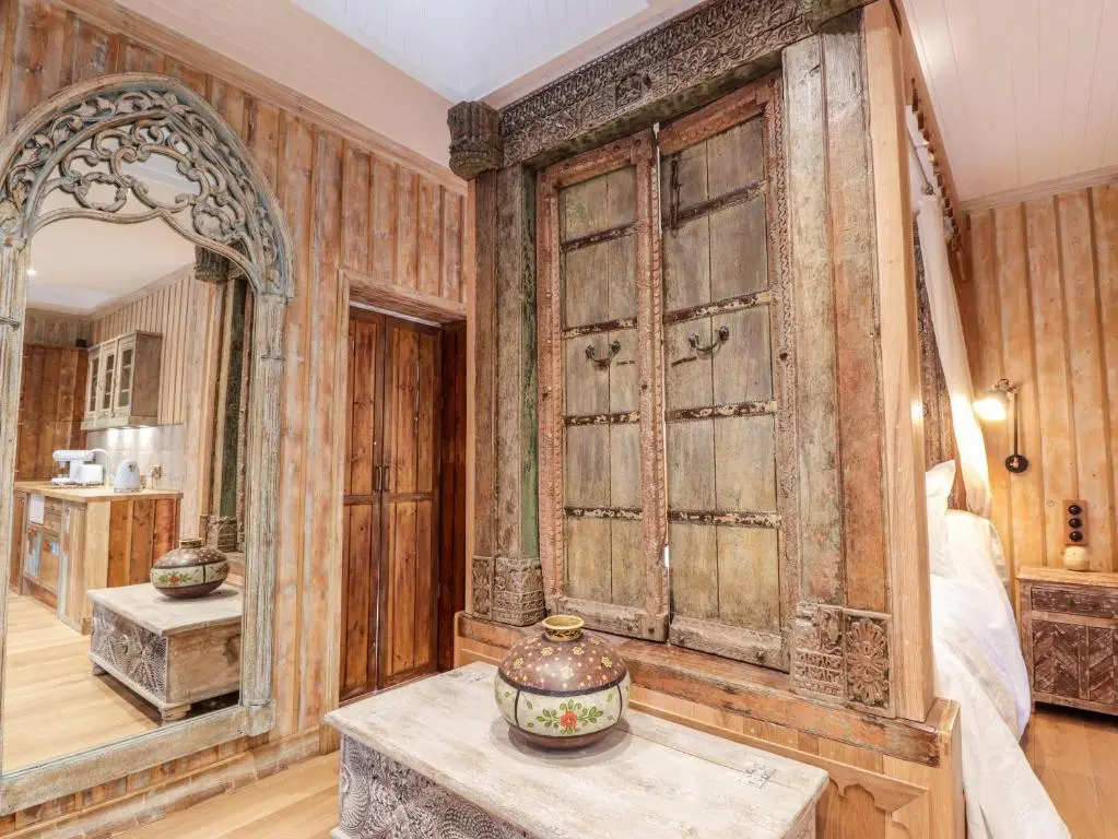 an old room with a mirror and a table at The Hen House in Beauly