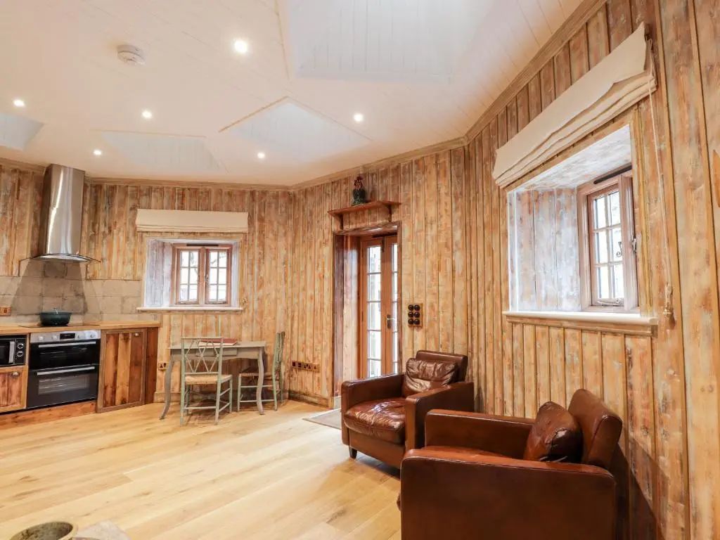 a living room with a couch and a table at The Hen House in Beauly