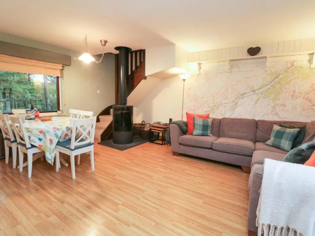 a living room with a couch and a table at The Shieling in Newtonmore
