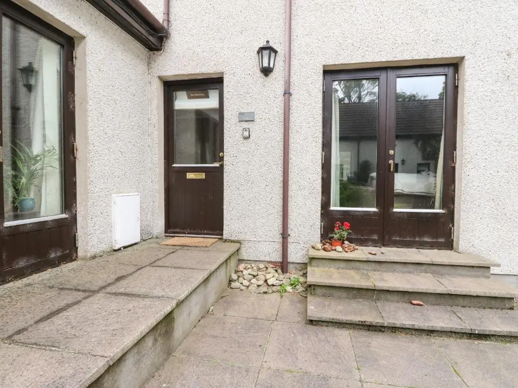 a house with a door and a window and a porch at The Shieling in Newtonmore