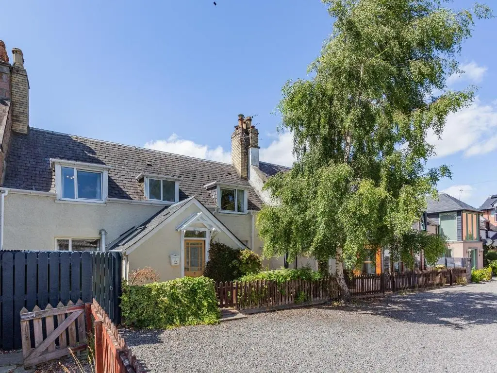 a house with a fence and a tree at Willow Cottage - Uk39244 in Inverness