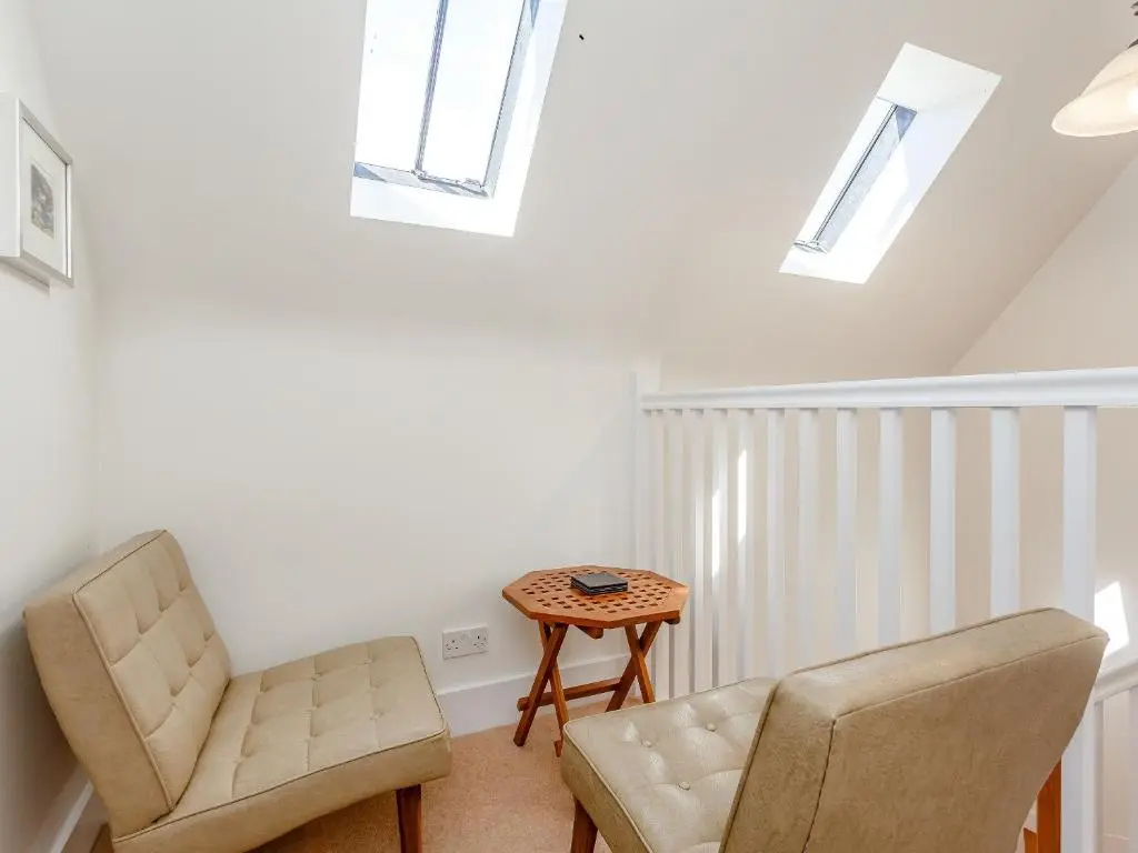 a living room with two chairs and a table at Willow Cottage - Uk39244 in Inverness