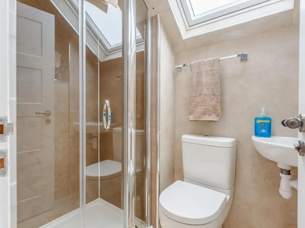 a bathroom with a shower and a toilet and a sink at Willow Cottage - Uk39244 in Inverness