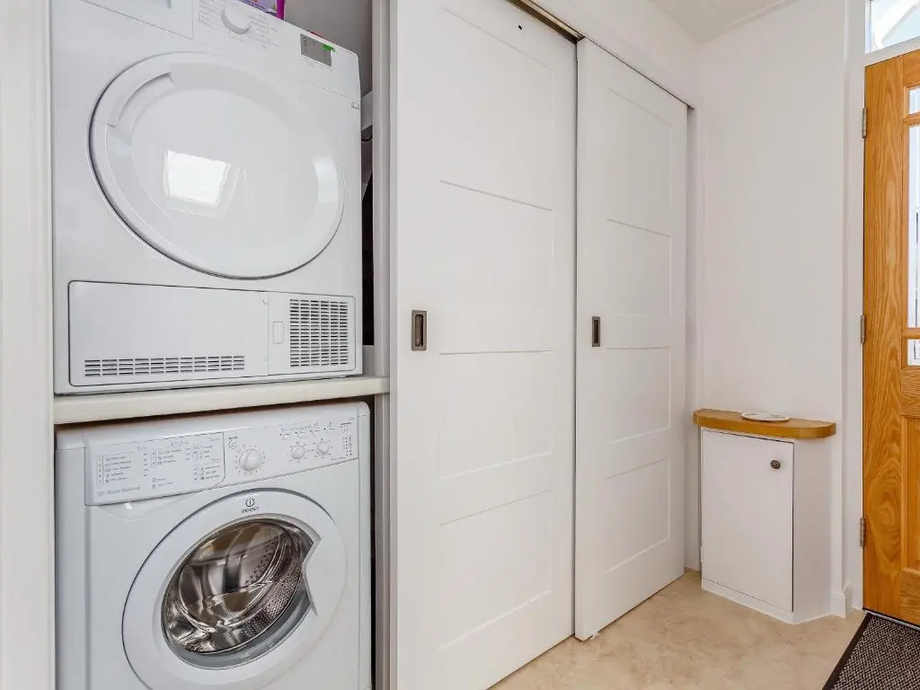a white laundry room with a washer and dryer at Willow Cottage - Uk39244 in Inverness