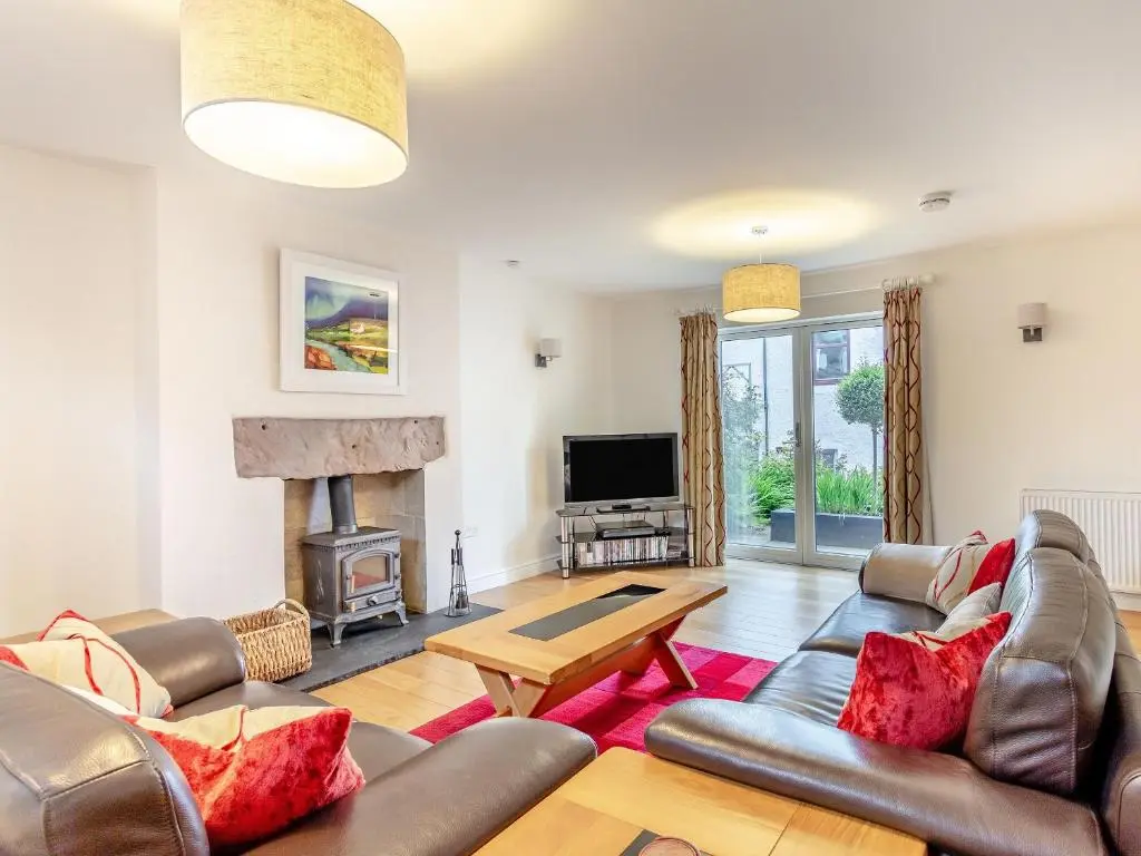 a living room with a couch and a fireplace at Rose Cottage - Uk39245 in Inverness