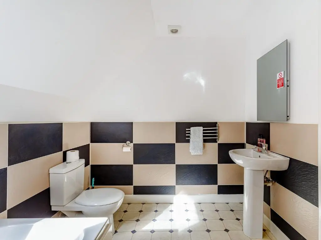 a bathroom with a toilet and a sink at Osprey Cottage- Ukc5519 in Boat of Garten