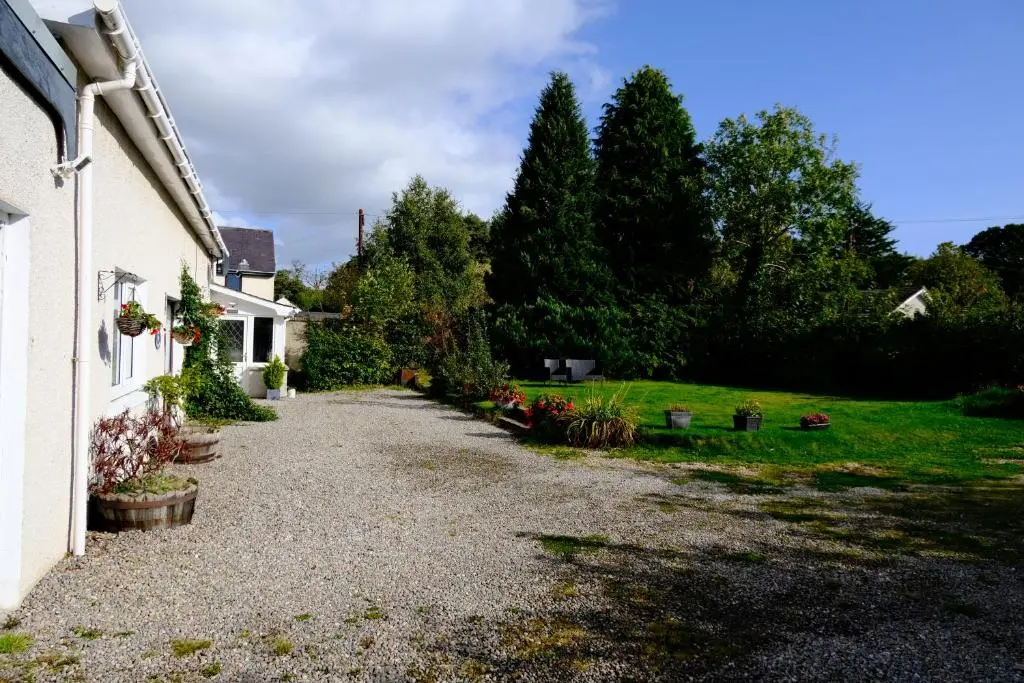 a driveway of a house with a yard at Lovely 1-bedroom apartment with free parking in Inverness