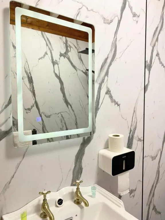 a bathroom with a sink and a mirror at Kaoglen-Blossom-Hot tub-Cairngorms-Pet Friendly in Balnald