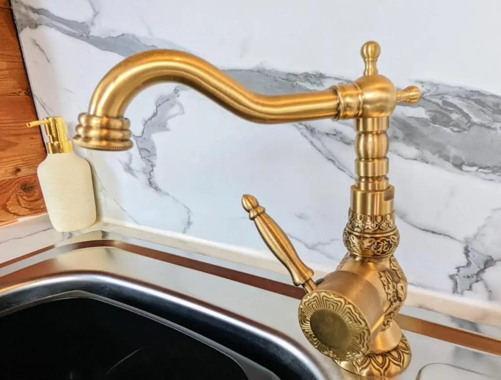 a gold faucet over a sink in a bathroom at Kaoglen Apollo-Hot tub-Cairngorms-Pet friendly in Balnald