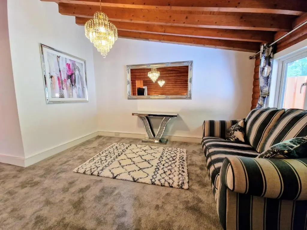 a living room with a couch and a table at Kaoglen Apollo-Hot tub-Cairngorms-Pet friendly in Balnald