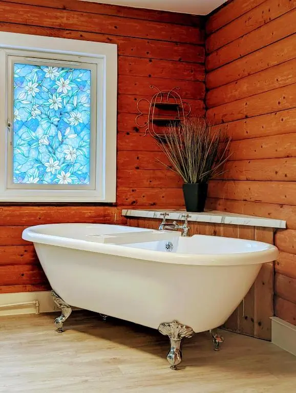 a white bath tub in a room with a window at Kaoglen Doe-Feature Bathroom-Cairngorms-Pets Allowed in Balnald
