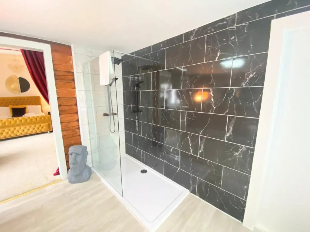 a bathroom with a shower with black tiles at Kaoglen Doe-Feature Bathroom-Cairngorms-Pets Allowed in Balnald