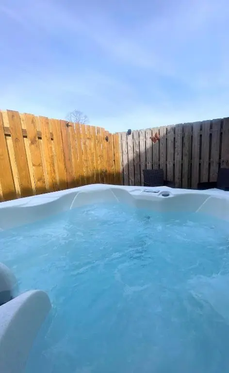 a pool of blue water next to a wooden fence at Kaoglen Zen-Feature Bath-Dunkeld-Route 500 in Balnald