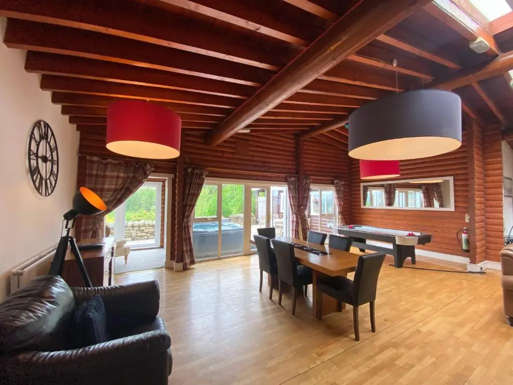 a living room with a table and chairs at Kaoglen-GrandSuite-Hot Tub-Pitlochry-Dunkeld-Pet Friendly in Balnald