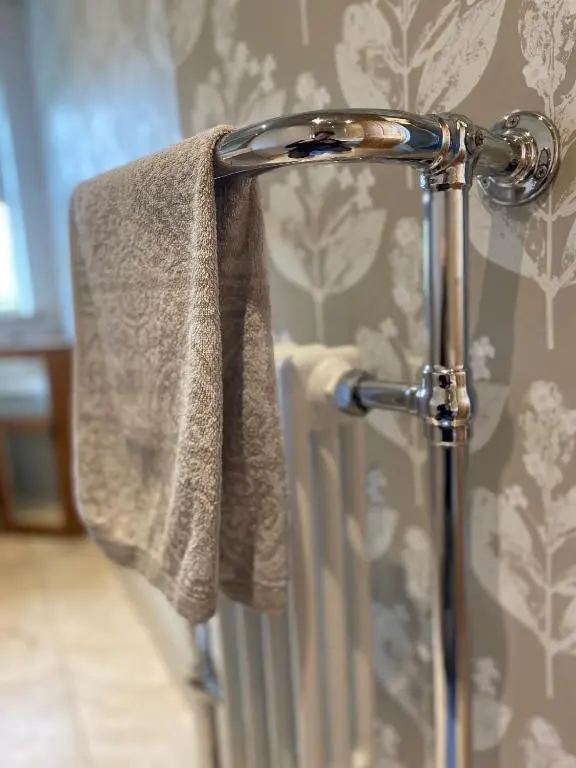 a towel hanging on a towel rack in a bathroom at Quirky Highland Cottage with Stunning Views in Wester Fearn