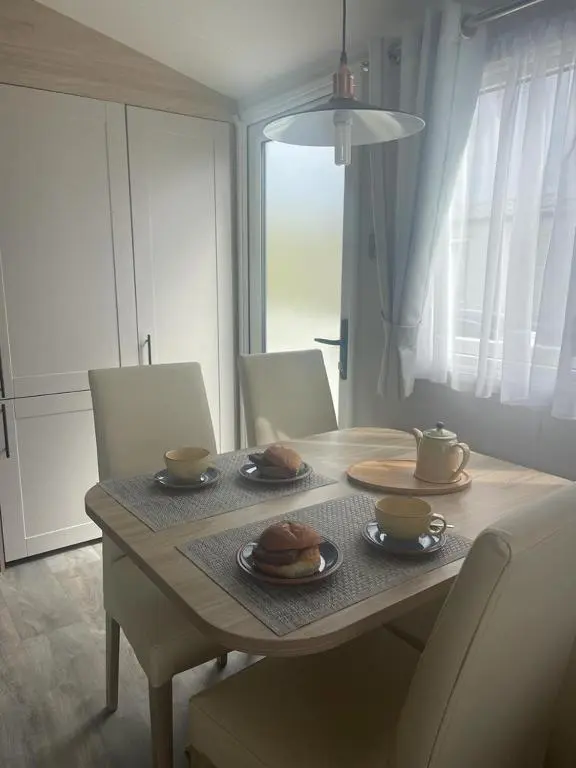 a dining room table with plates of food on it at Dune View Caravan in Lossiemouth