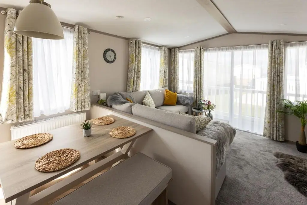 a living room with a couch and a table at The Beach Hut, Burghead in Burghead