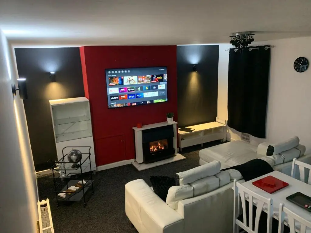 a living room with a couch and a tv at Stylish apartment in the heart of Inverness in Inverness