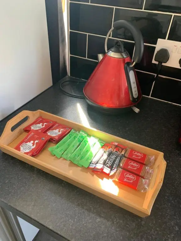 a tray of utensils on a kitchen counter with a tea kettle at Stylish apartment in the heart of Inverness in Inverness