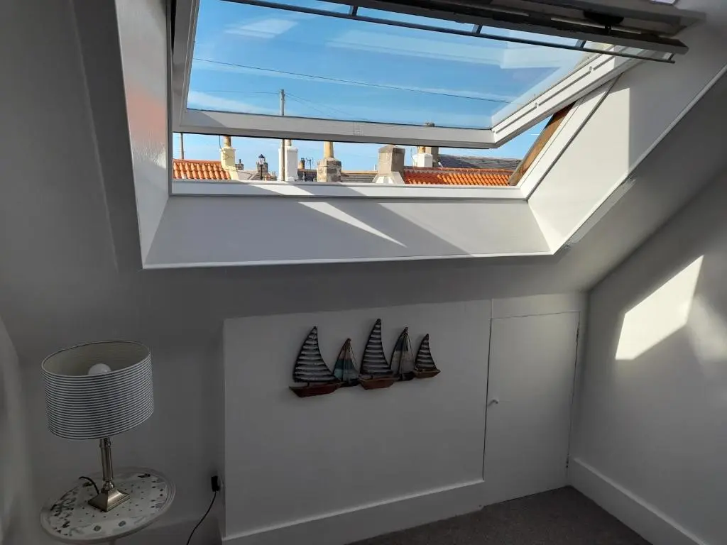 a skylight in a room with two mothshib at Creel Cottage Seatown Cullen with Garden in Cullen