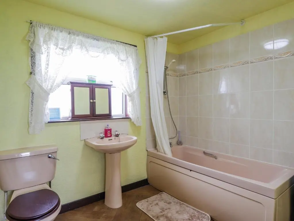 a bathroom with a sink and a toilet and a tub at Star Croft in Wick
