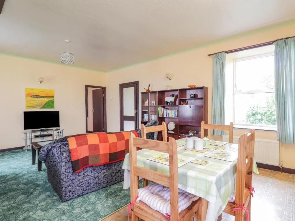 a living room with a table and a couch at Star Croft in Wick