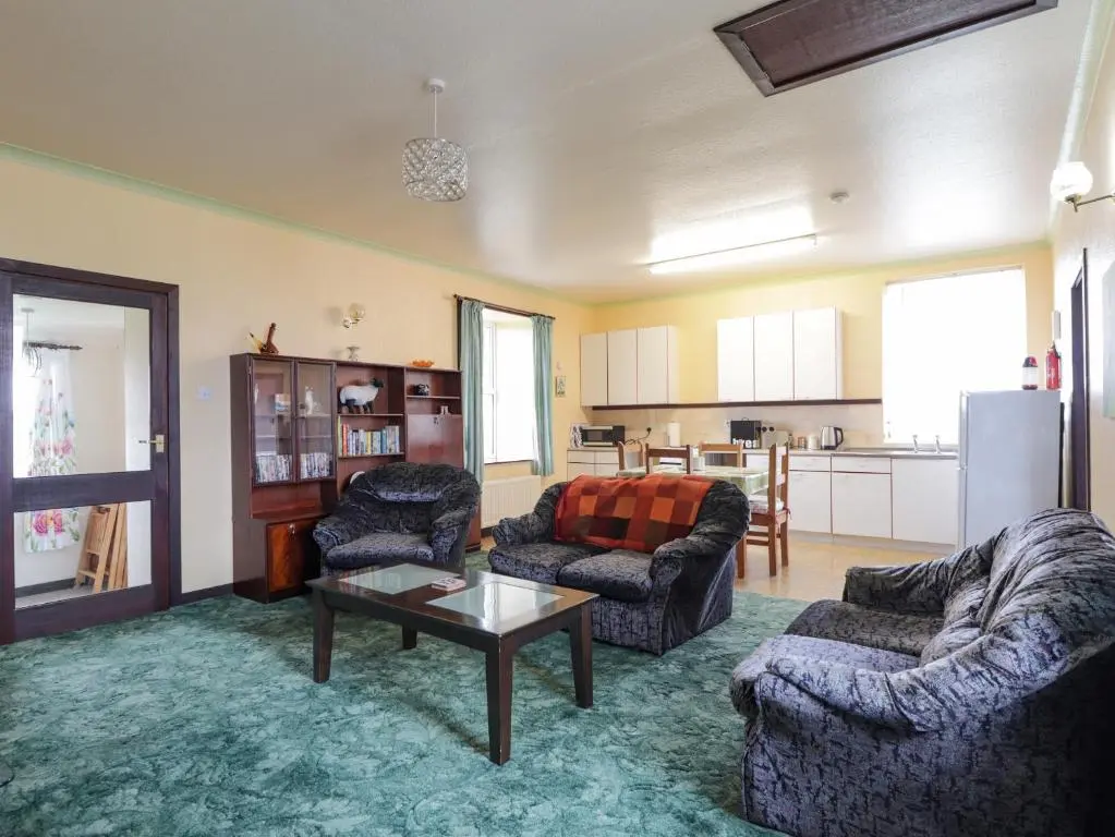 a living room with two couches and a table at Star Croft in Wick