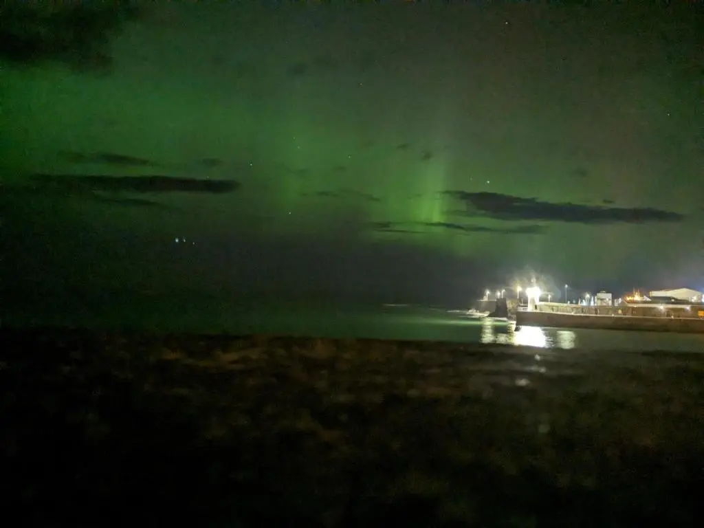 a view of the aurora over the water at night at Braeview Studio in Macduff