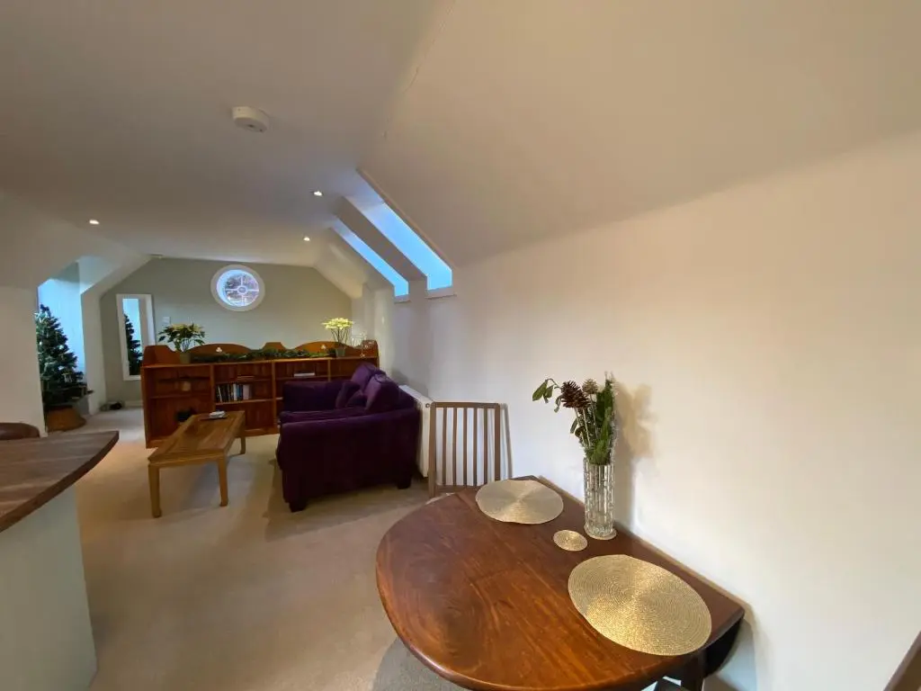 a living room with a table and a couch at Brylach Steading in Aberlour