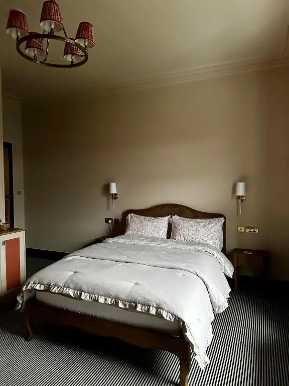 a bedroom with a large bed with white blankets and pillows at The Pines Guest House in Elgin