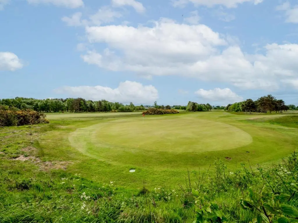 a view of the green at a golf course at Holiday Home Golf View by Interhome in Nairn