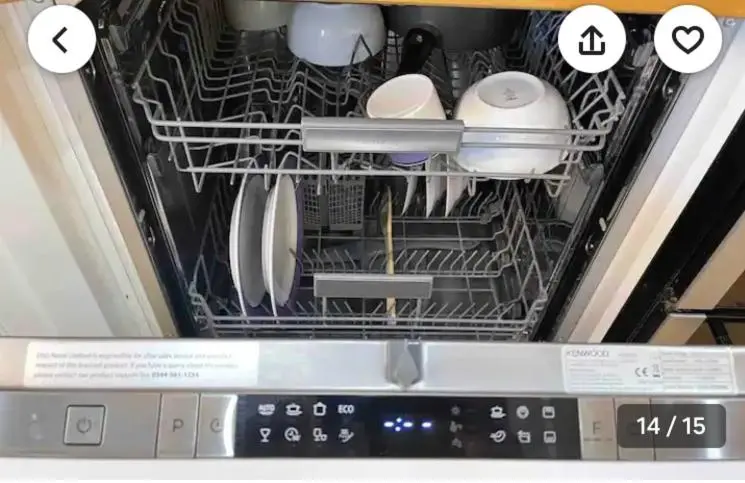 an open dishwasher with dishes and utensils in it at The Castle Front Nest in Inverness
