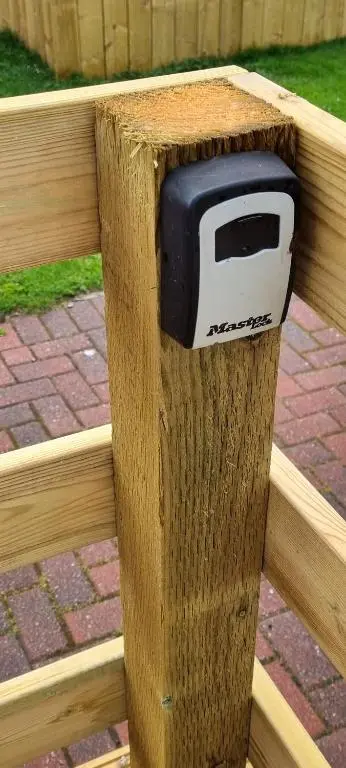 a wooden fence with a toaster sticking out of it at The Wee Hoose in Boat of Garten