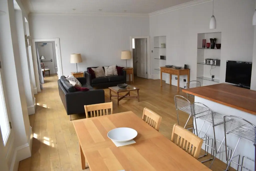 a living room with a table and a couch at Central 1-Bed Apartment in Inverness Sleeps 4 in Inverness