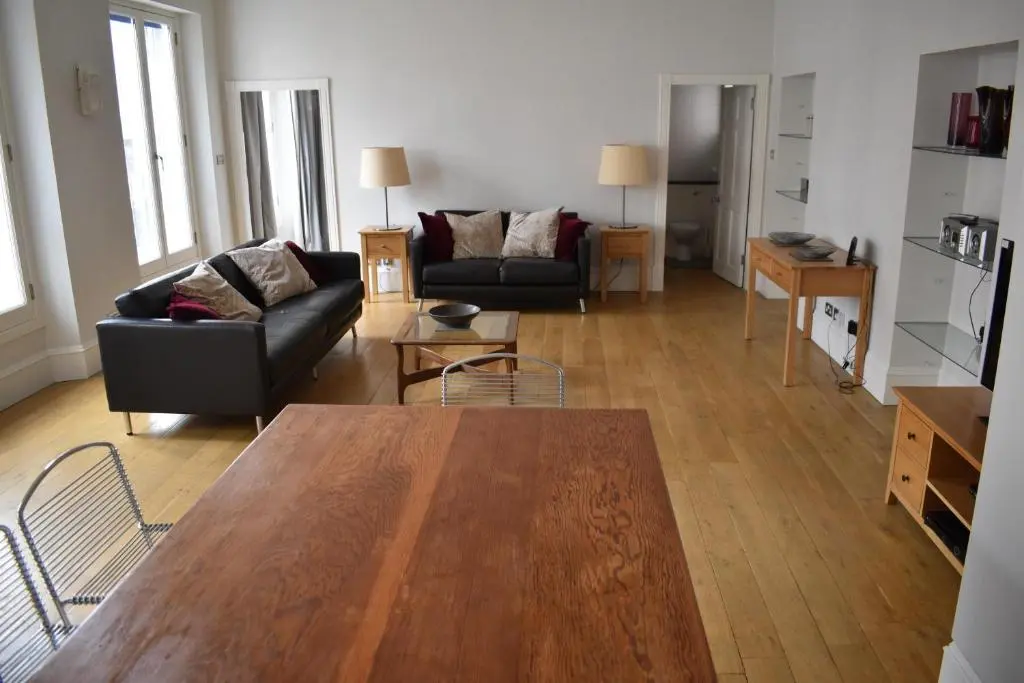 a living room with a table and a couch at Central 1-Bed Apartment in Inverness Sleeps 4 in Inverness
